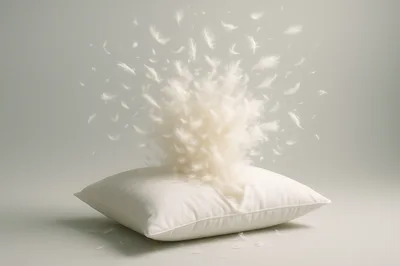 White Pillow Bursting With Flying Feathers
