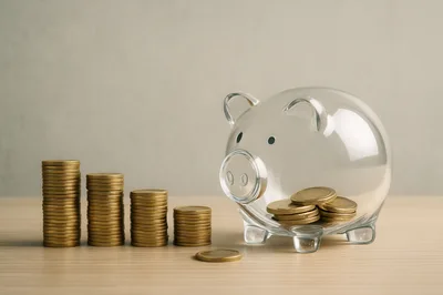 Clear Glass Piggy Bank With Stacks Of Gold Coins