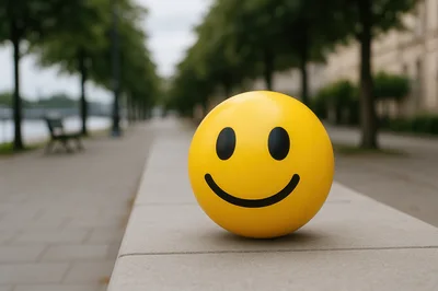 Yellow Smiley Face Ball On A Stone Wall