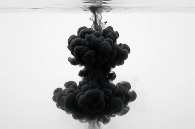 Black Ink Dropping Into Clear Water