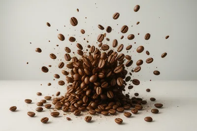 Explosion Of Roasted Coffee Beans On White Surface