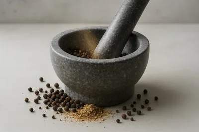 Stone Mortar and Pestle Grinding Black Peppercorns