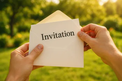 Hands Holding An Open Envelope With Invitation Card