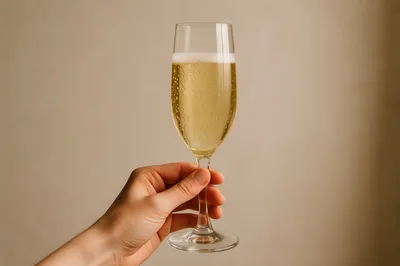 Hand Holding A Glass Of Sparkling Champagne