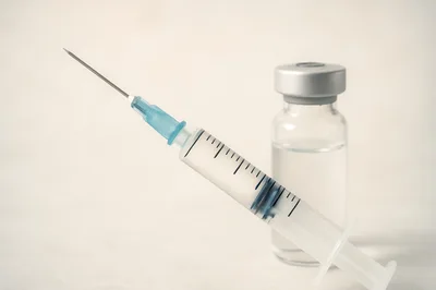 Medical Syringe And Glass Vial On White Background
