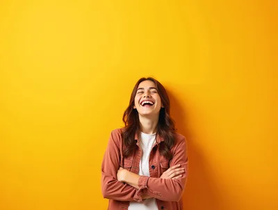 Happy Young Woman Laughing Against Yellow Background