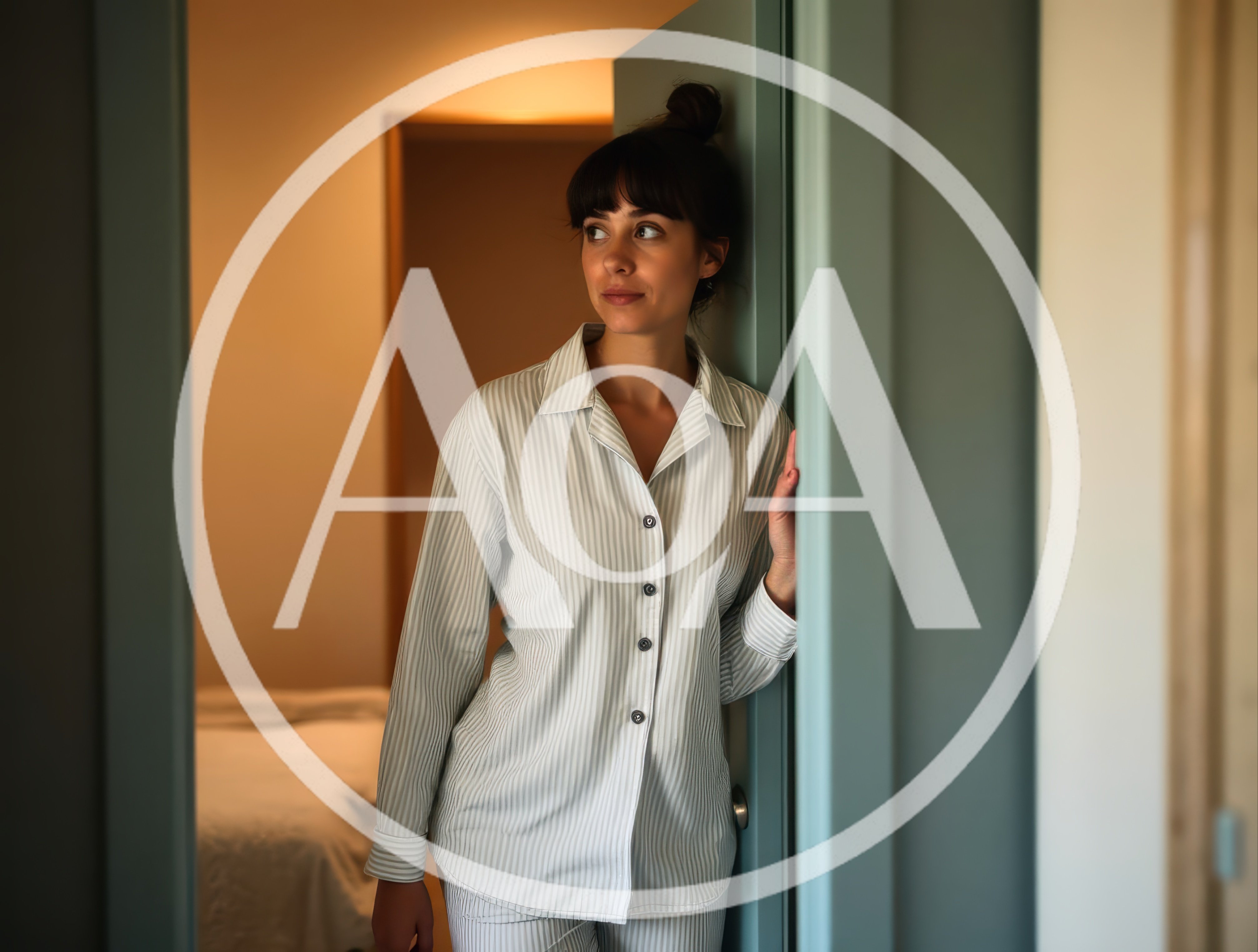 Young Woman Standing In Bedroom Doorway In Pajamas