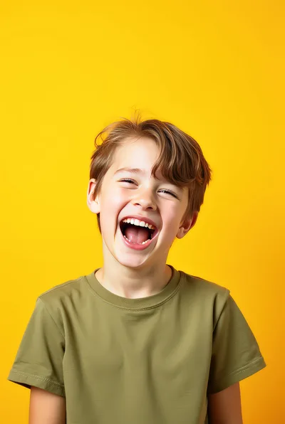 Happy Young Boy Laughing Against Yellow Background