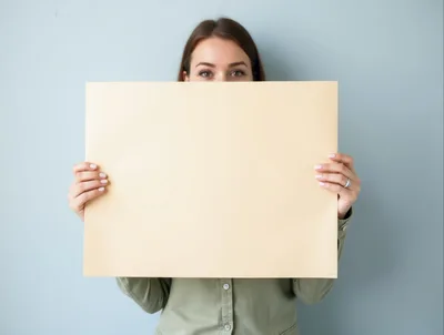Woman Holding Blank Beige Poster Board
