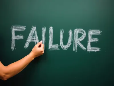 Hand Writing The Word Failure On A Green Chalkboard