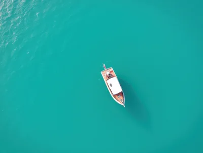 Aerial View Of A Classic Wooden Motorboat On Turquoise Water
