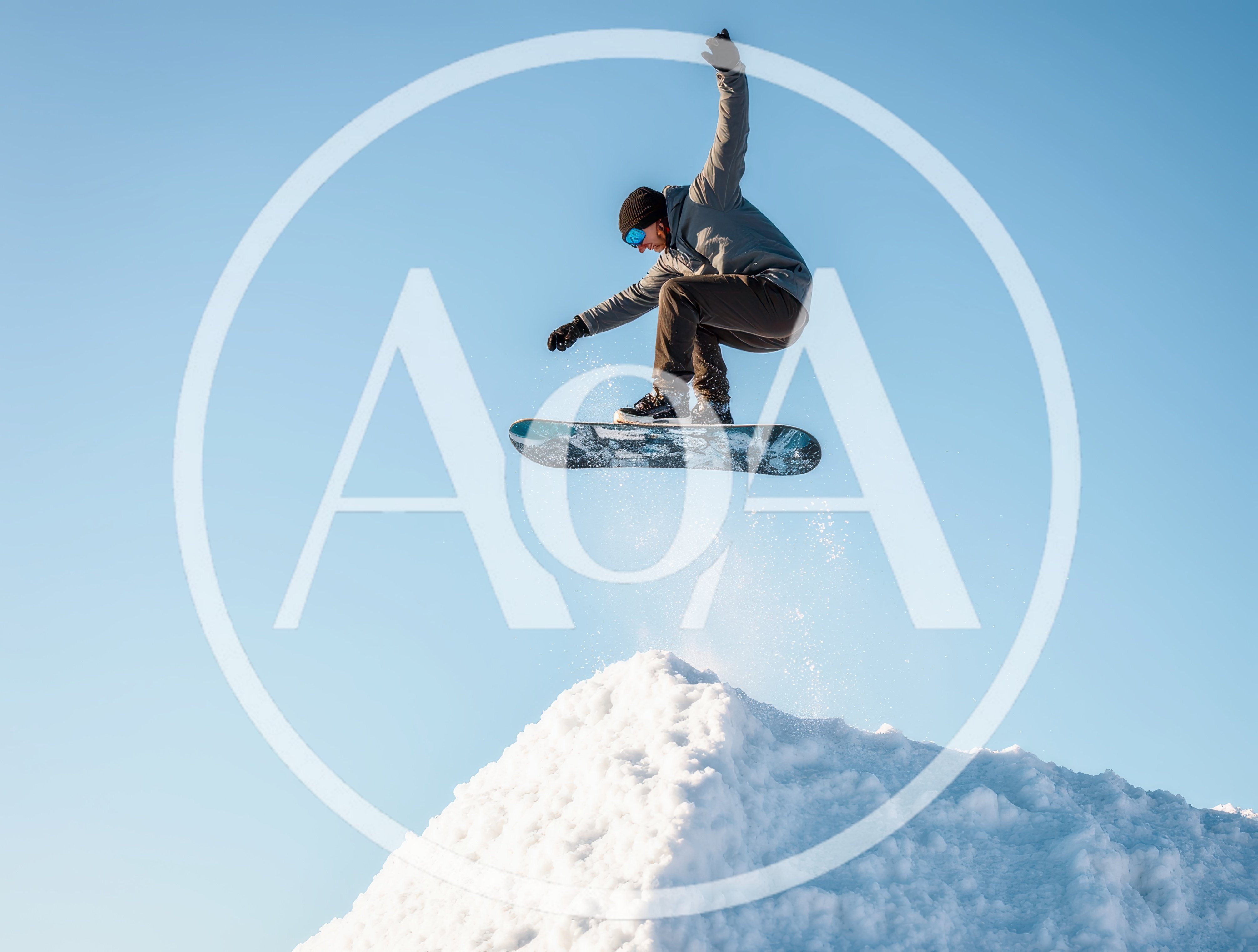 Snowboarder Performing A High Jump Over A Snow Mound