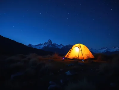 Illuminated Camping Tent Under Starry Mountain Night Sky
