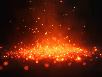 Glowing Orange Fire Sparks Rising From Dark Ground