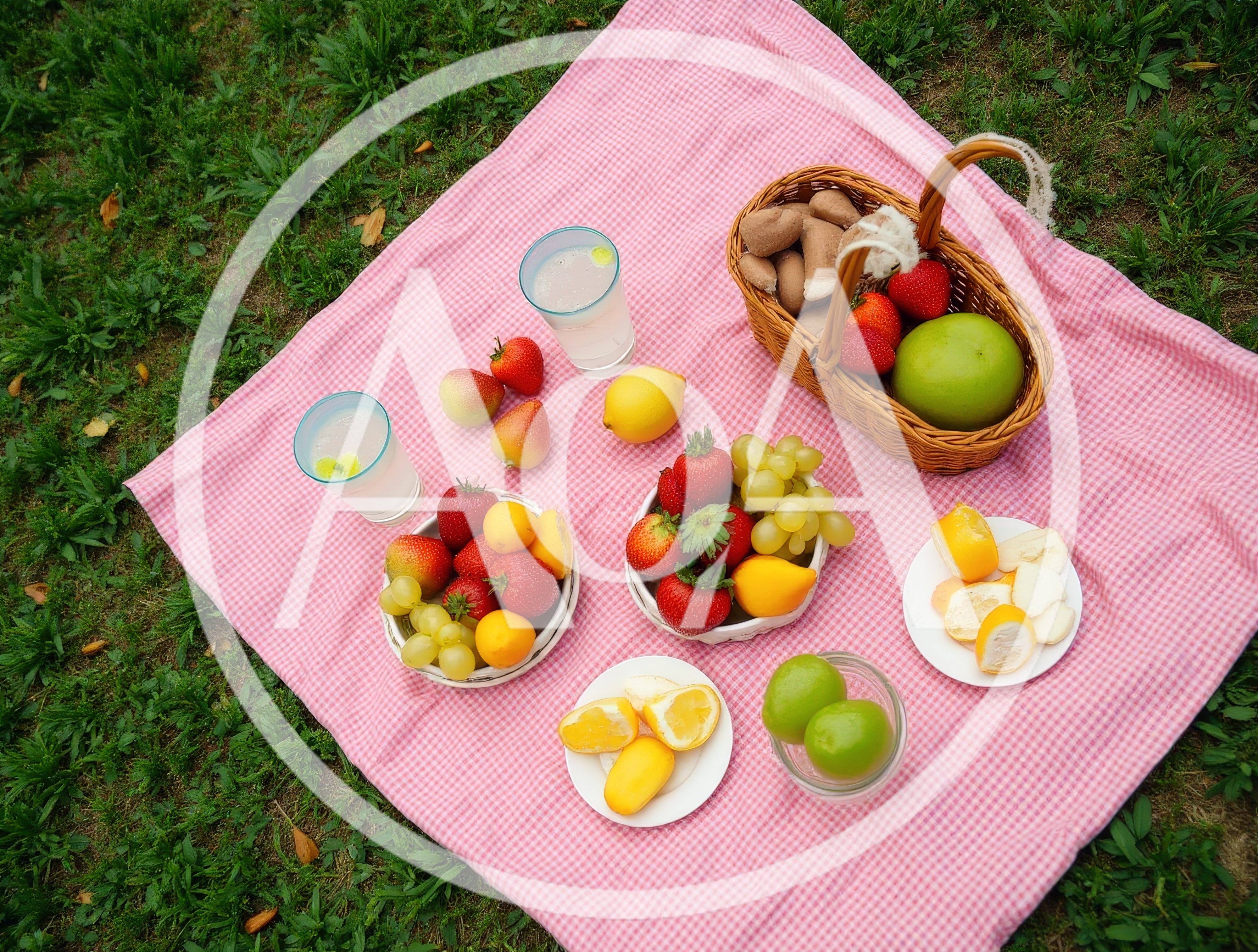 Picnic Setup With Fresh Fruit And Drinks On A Blanket