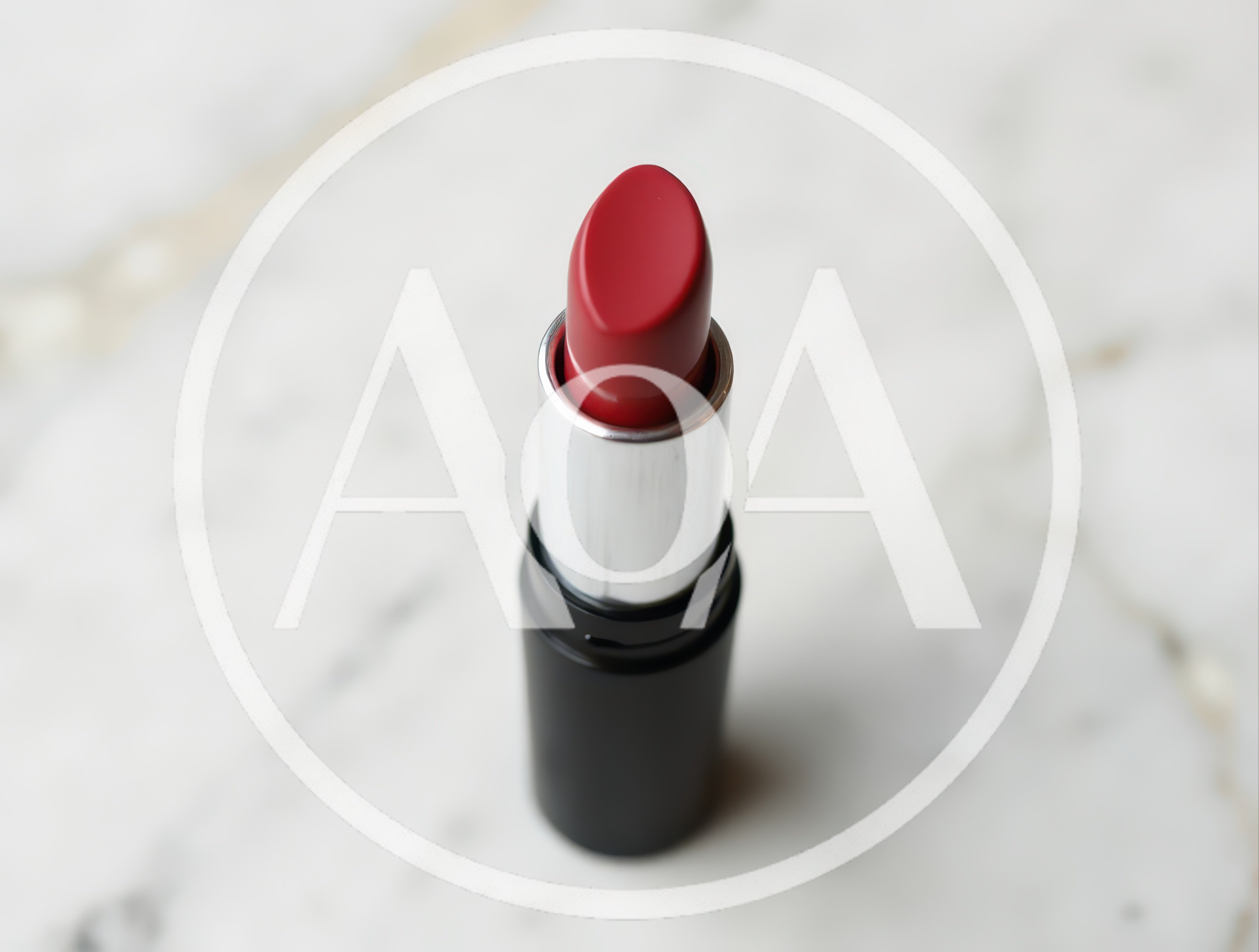 Red Lipstick Tube Standing On White Marble Surface