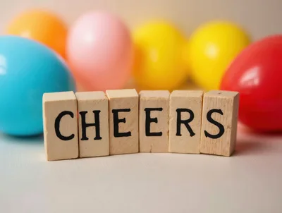 Wooden Blocks Spelling Cheers With Colorful Easter Eggs