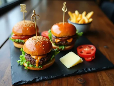 Three Gourmet Sliders Served On A Slate Platter