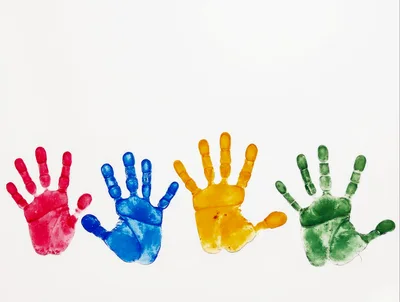 Four Colorful Handprints On White Background
