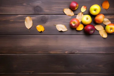 Fresh Apples And Autumn Leaves On Dark Wooden Background