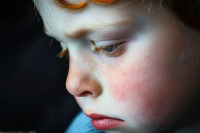 Close Up Portrait Of A Young Child With Red Hair