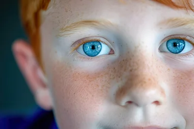 Close Up Portrait Of A Young Boy With Blue Eyes
