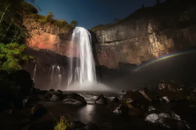 Majestic Waterfall At Night With Lunar Rainbow