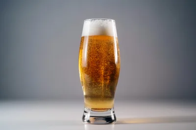 Glass Of Golden Beer With Frothy Head