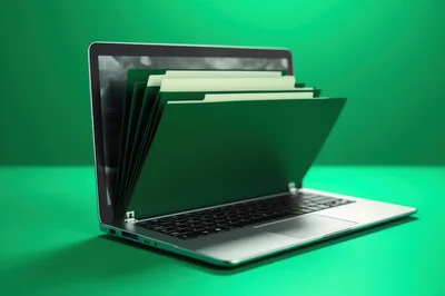 Laptop Computer With Green File Folders Emerging From Screen