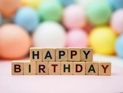 Happy Birthday Wooden Blocks on Pastel Background