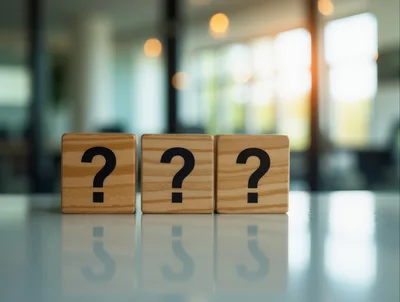 Three Wooden Blocks With Question Marks On A Table
