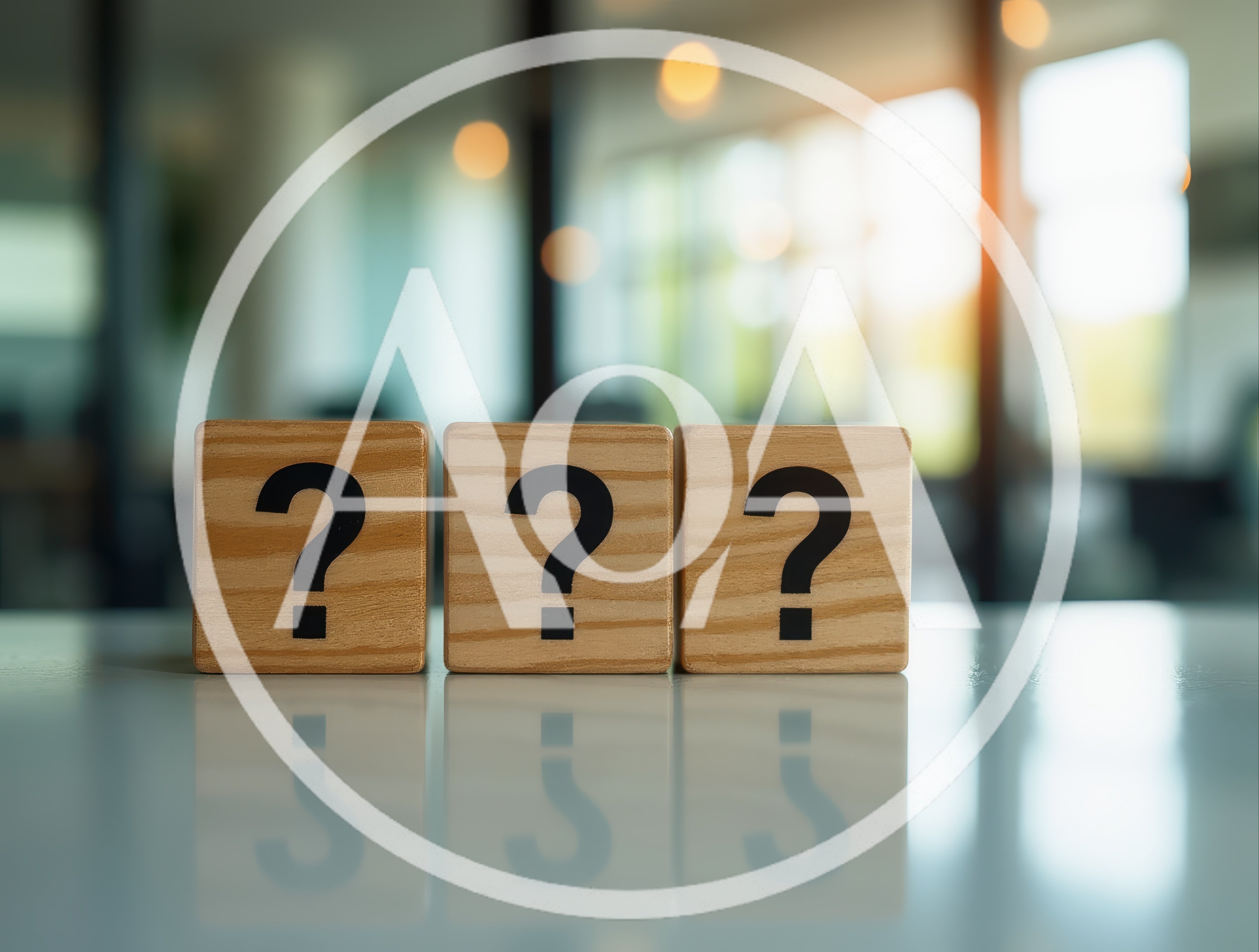 Three Wooden Blocks With Question Marks On A Table