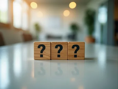 Three Wooden Blocks With Question Marks On Table