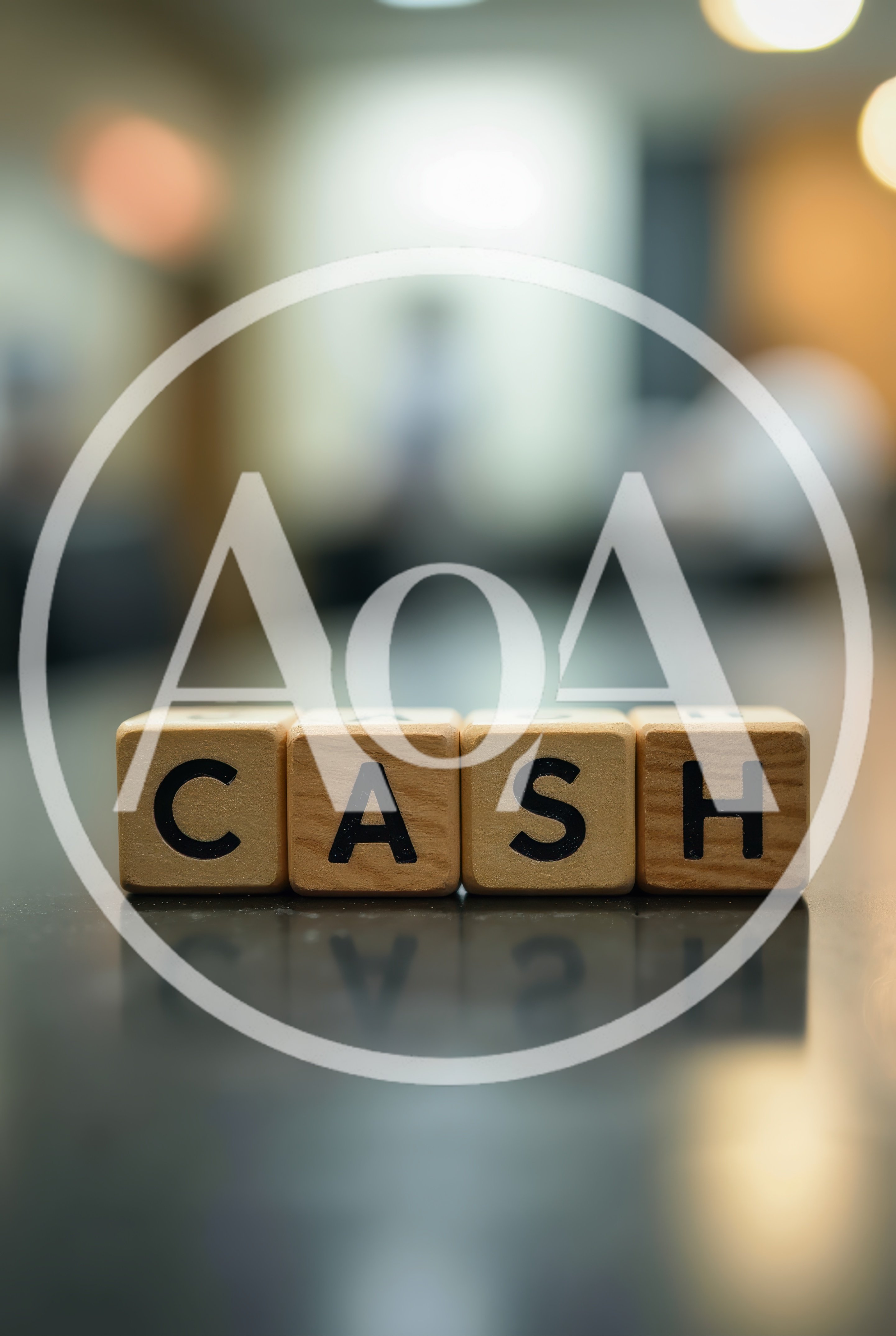 Wooden Blocks Spelling Cash On A Reflective Surface