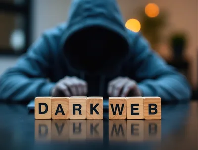 Hacker Working On Laptop With Dark Web Wooden Blocks