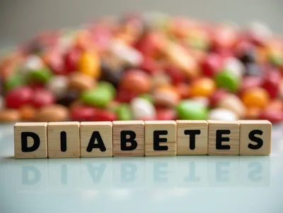 Wooden Blocks Spelling Diabetes With Blurred Candy Background
