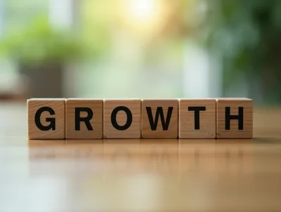 Wooden Blocks Spelling Growth on a Wooden Table