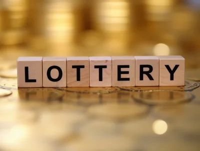 Wooden Blocks Spelling Lottery On A Pile Of Gold Coins