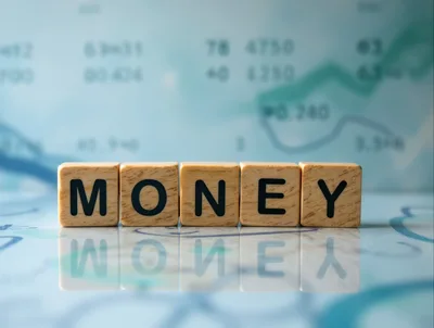 Wooden Blocks Spelling Money on Financial Chart Background