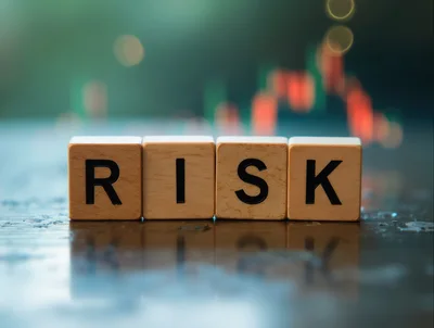 Wooden Blocks Spelling Risk With Blurred Financial Chart Background