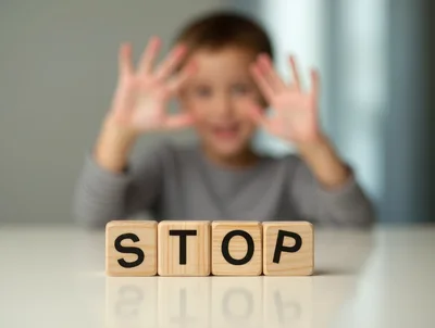 Child Holding Hands Up Behind Wooden Stop Blocks