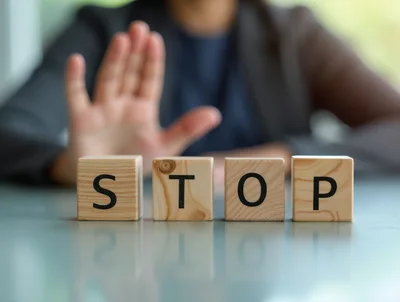 Business Person Making Stop Gesture Behind Wooden Blocks