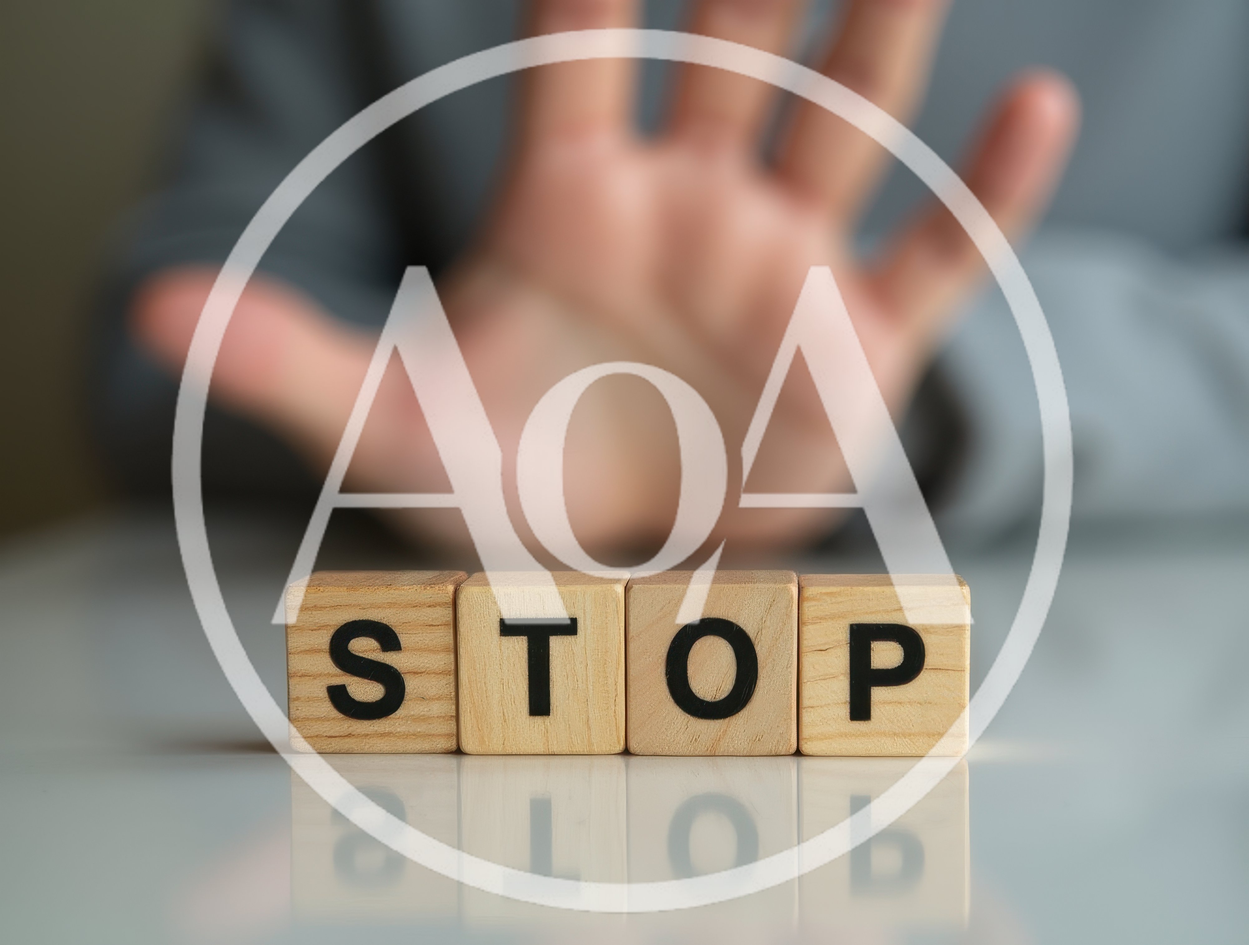 Hand Gesturing Stop Behind Wooden Blocks Spelling Stop