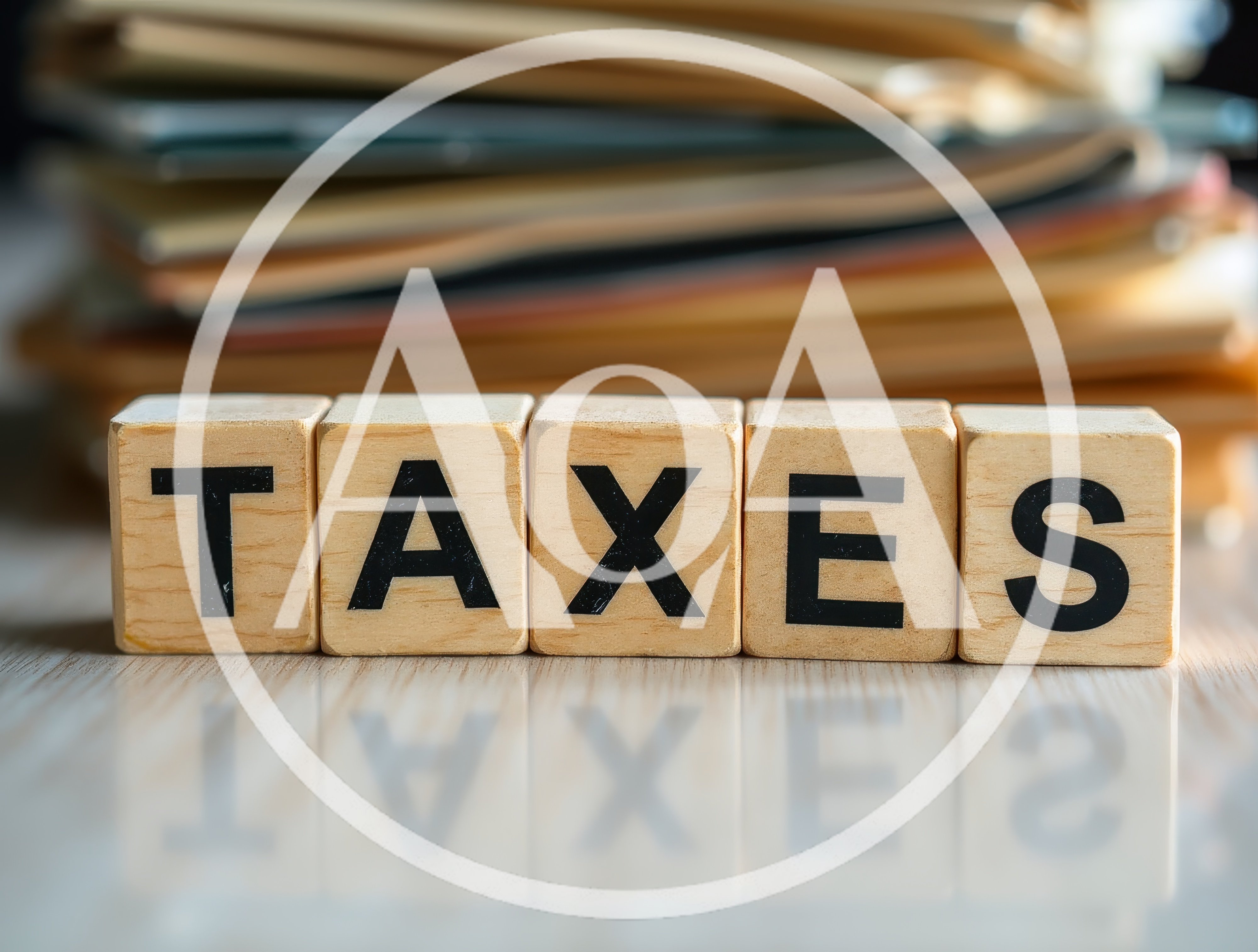 Wooden Blocks Spelling Taxes With Blurred File Folders