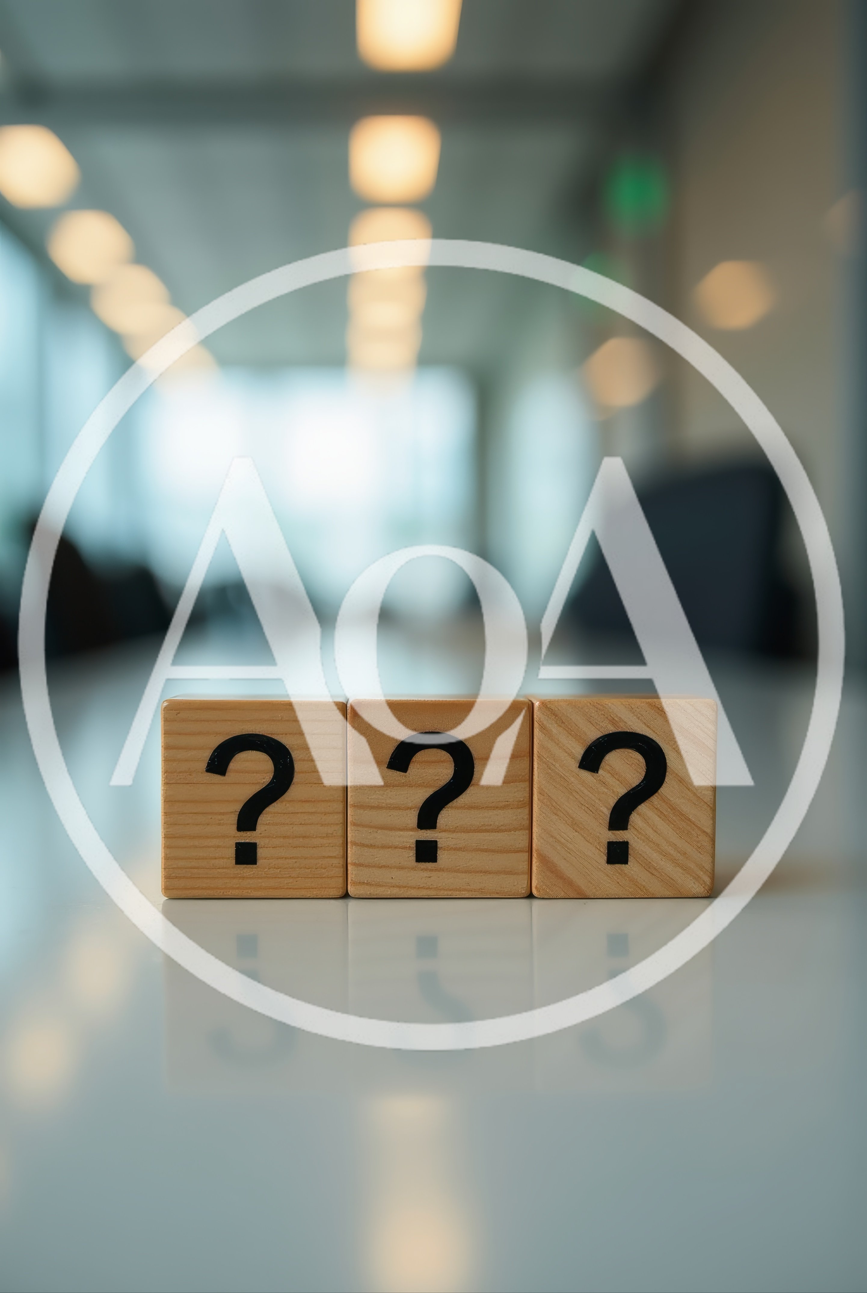 Three Wooden Blocks With Question Marks On Office Table