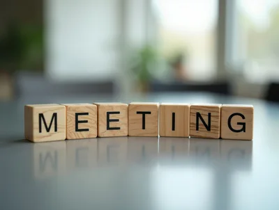 Wooden Blocks Spelling Meeting On A Reflective Table