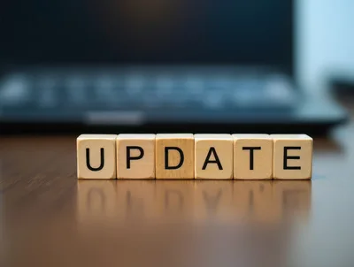 Wooden Blocks Spelling Update On A Desk