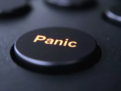Illuminated Panic Button On A Dark Control Panel