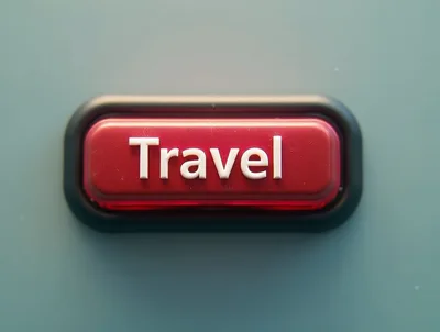 Red Travel Button With White Text On Grey Background