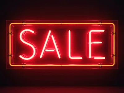 Bright Red Neon Sale Sign On Dark Wall